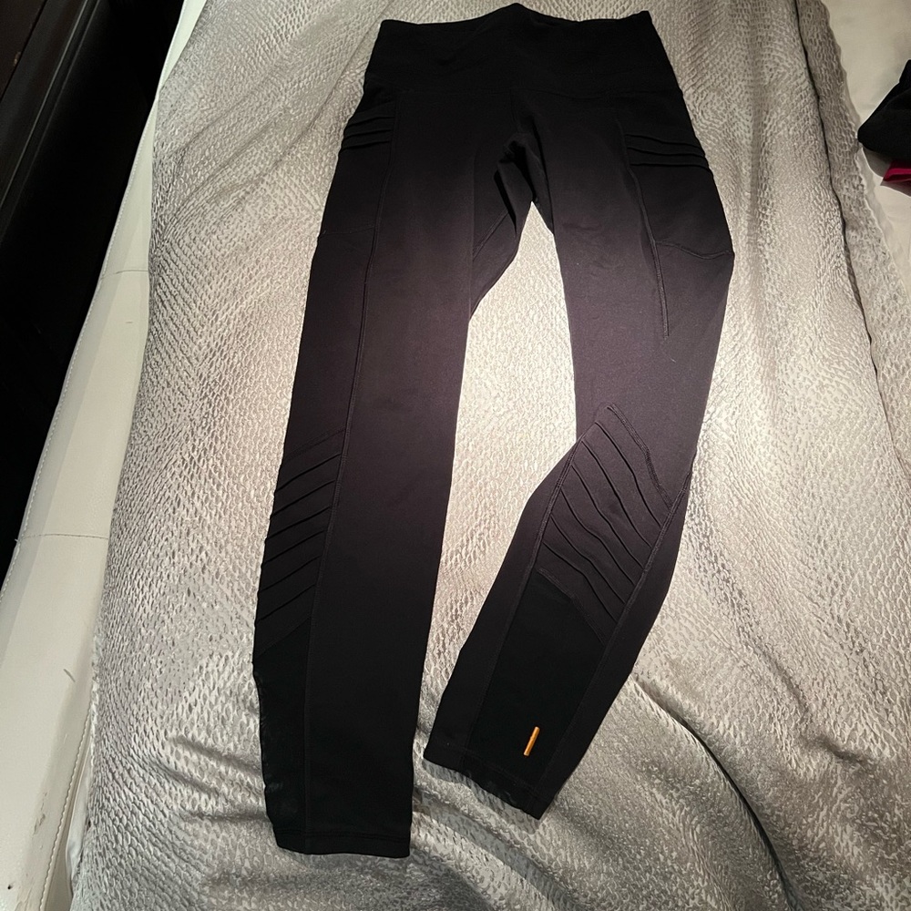 black cropped leggings with moto accents and mesh